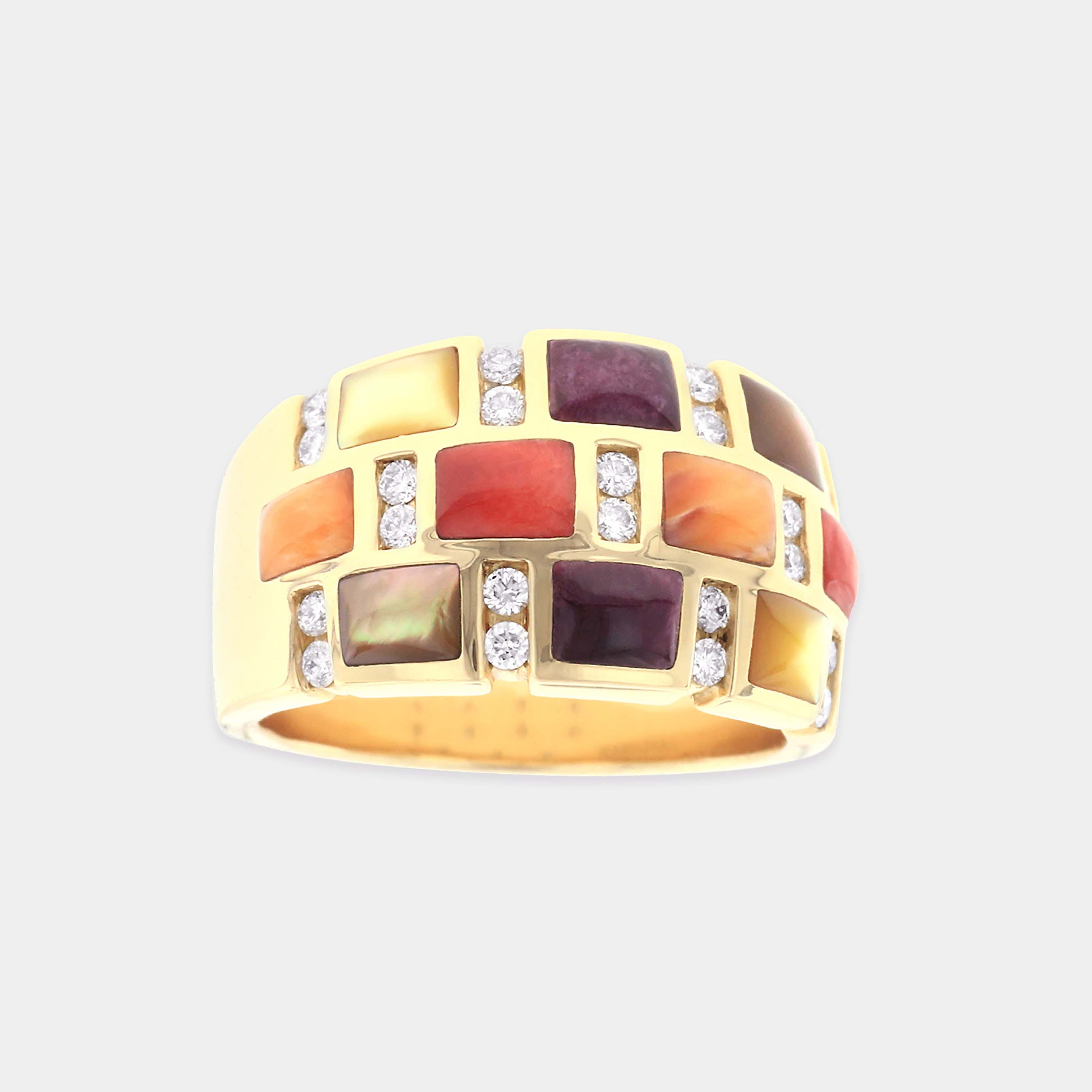 Yellow gold multi colored mother of pearl ring on grey background
