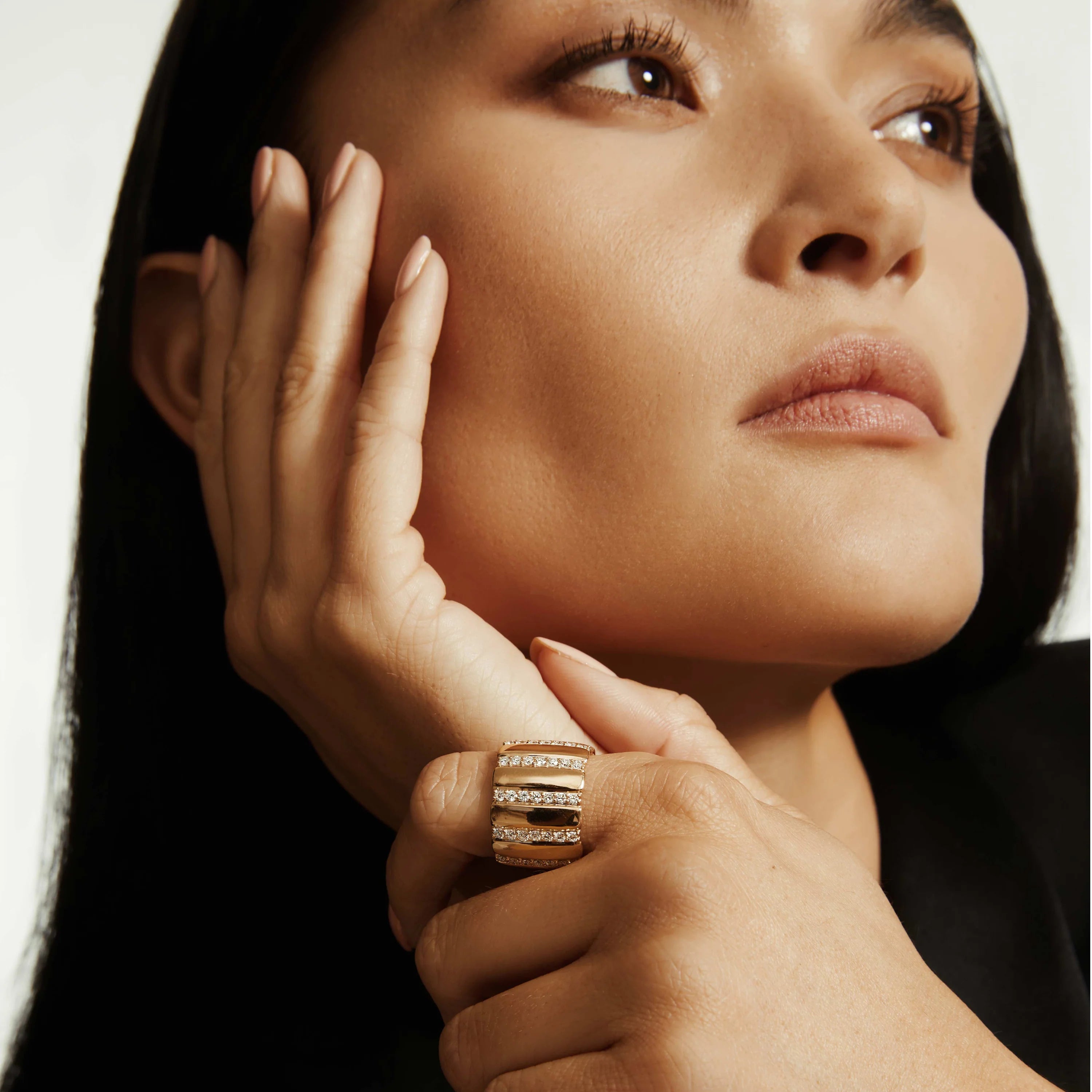 Woman wearing yellow gold and diamond ribbed ring