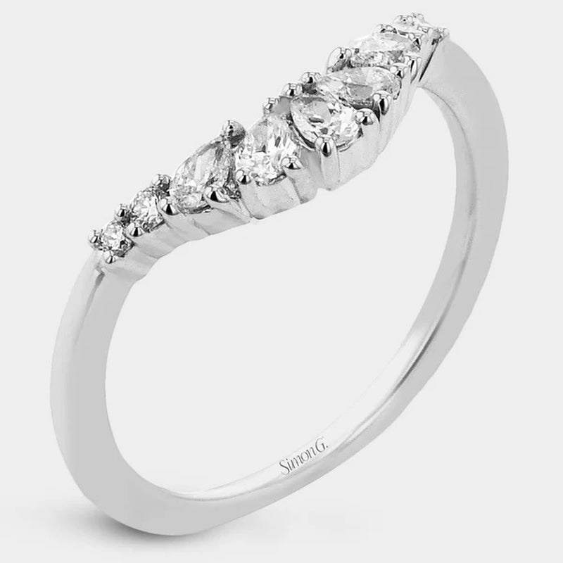 Diamond ring with pear-shaped stones on a white background