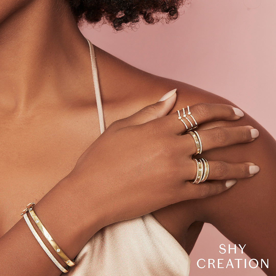 Woman wearing yellow gold bezel set fashion ring