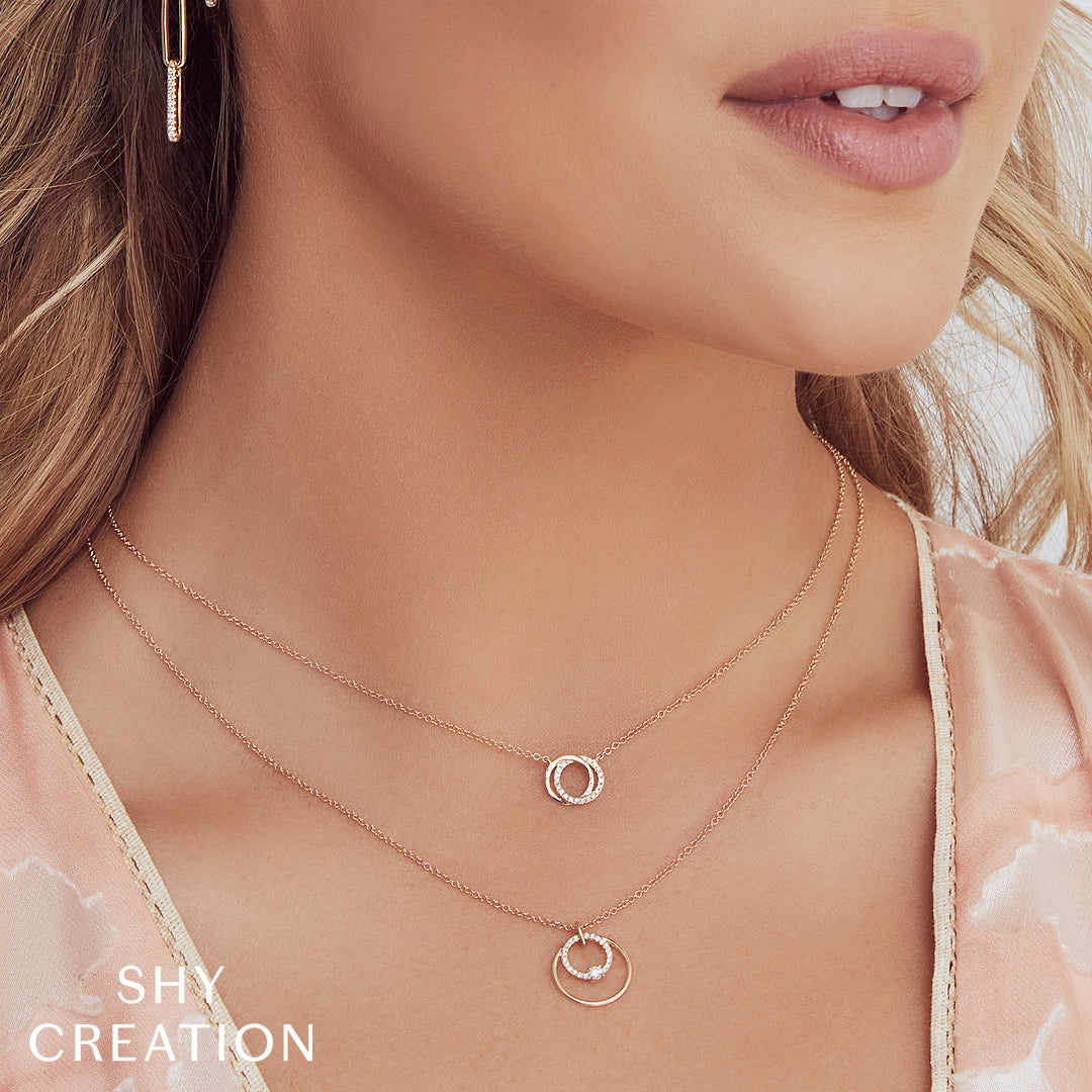Close-up of a woman wearing interlocking circle diamond pendant necklace