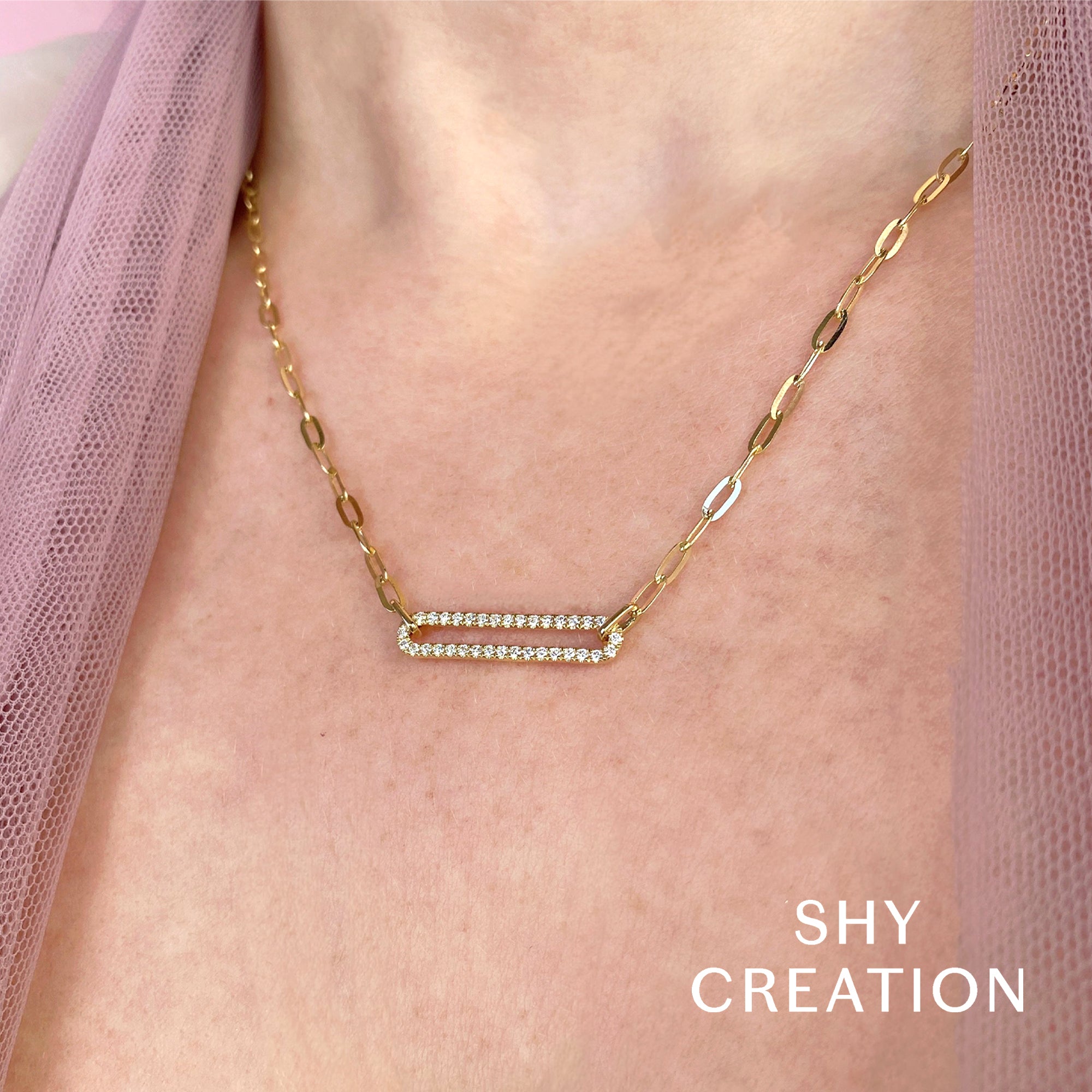 Woman wearing yellow gold diamond paperclip link necklace