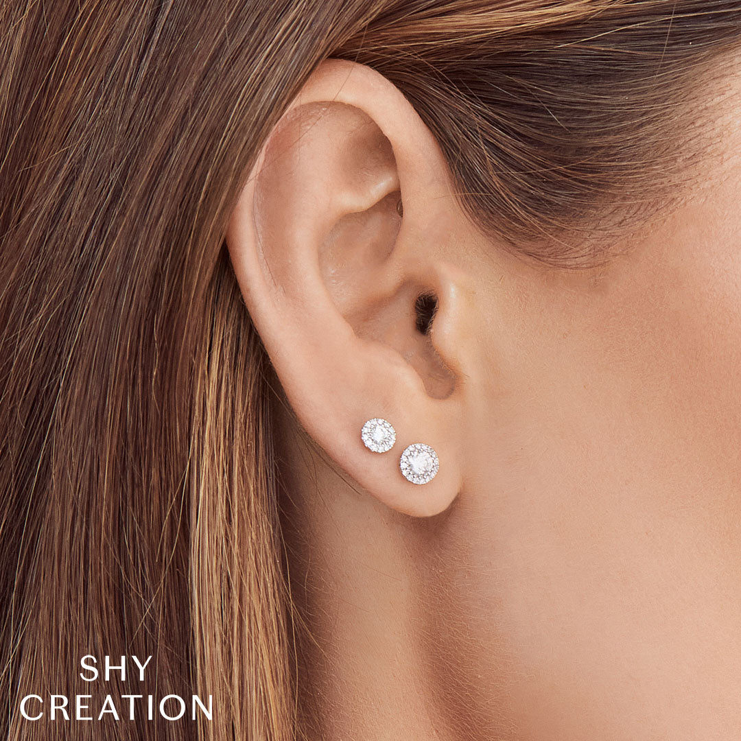 Woman wearing white gold diamond halo stud earring