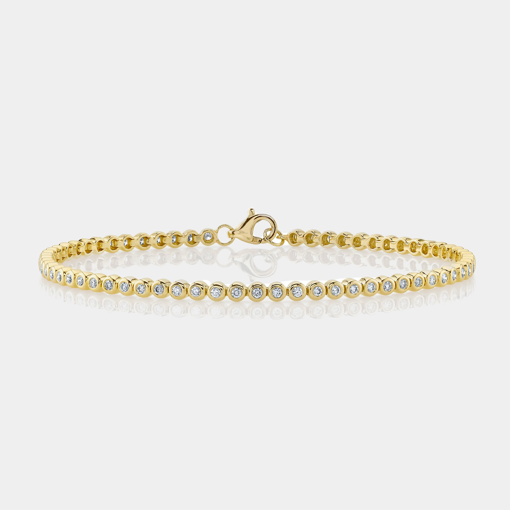Yellow gold bezel set diamond tennis bracelet, front angle view