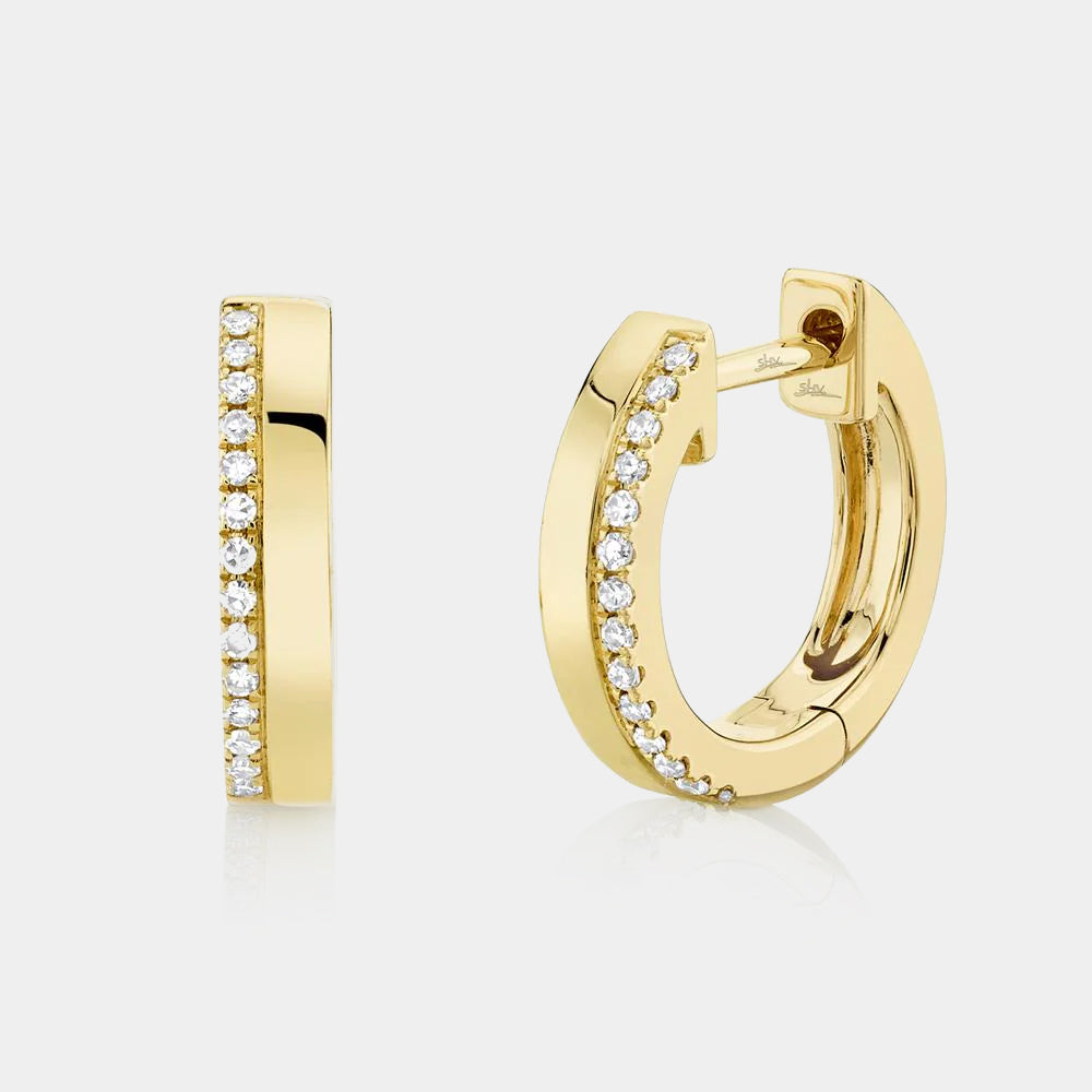 Yellow gold diamond huggie earrings, front angle view