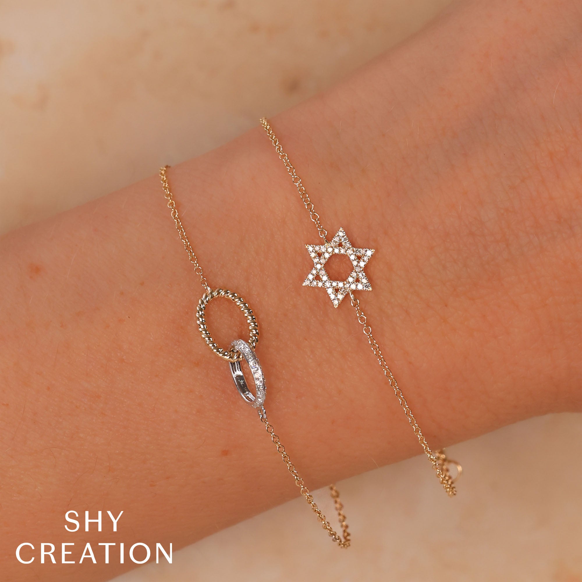 Woman wearing yellow gold diamond oval bracelet, wrist close-up