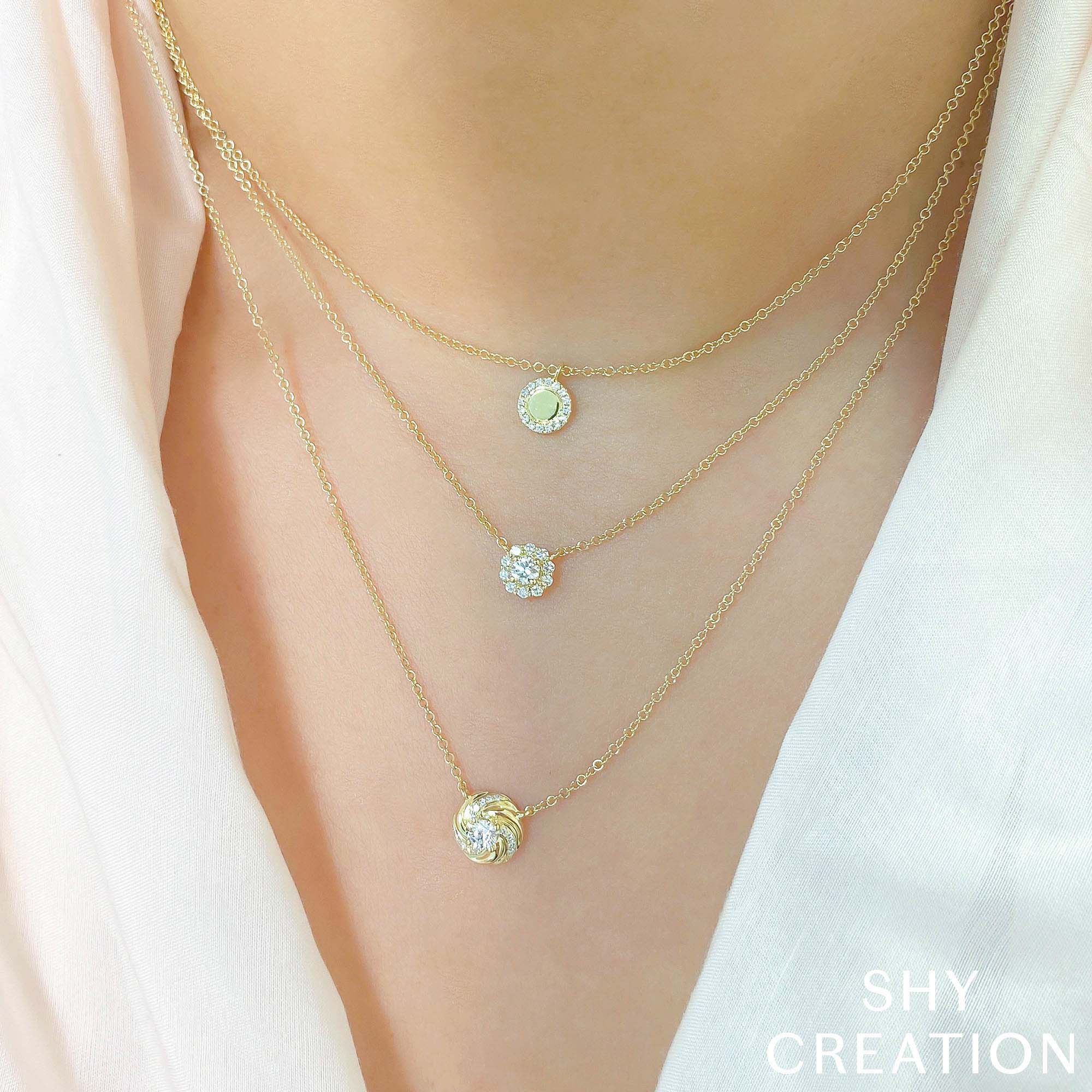 Woman wearing yellow gold polished center diamond pendant necklace