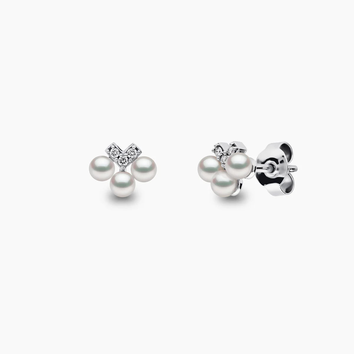 White gold pearl and diamond v drop earrings on grey background, front and side angle view