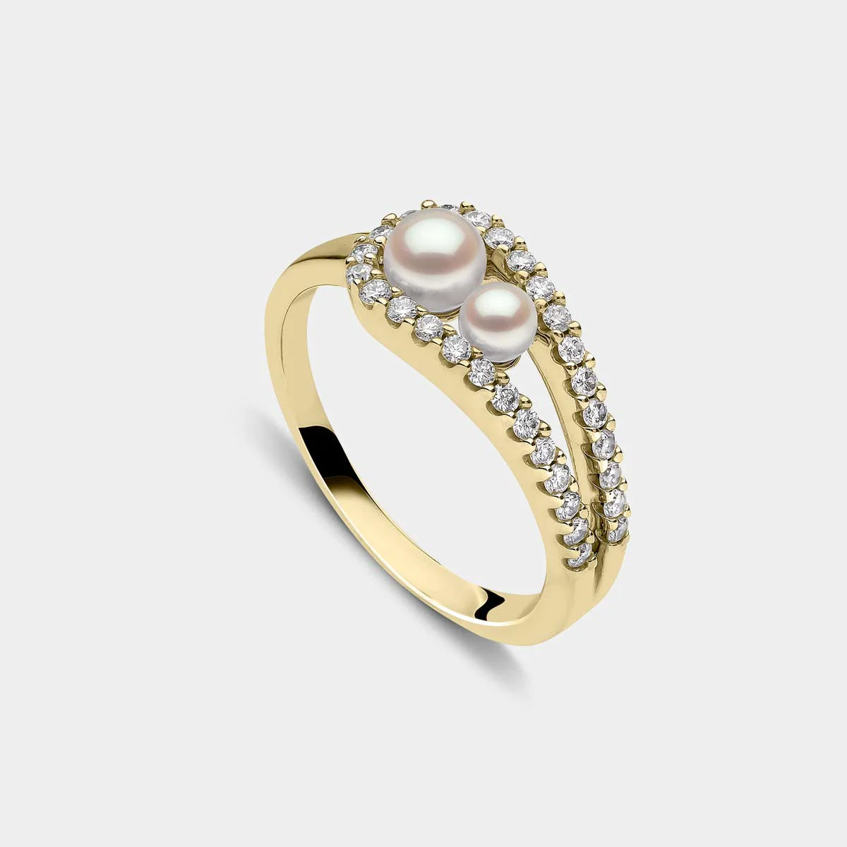 Yellow gold fashion ring with two white pearls and diamond accents on grey background, side angle view