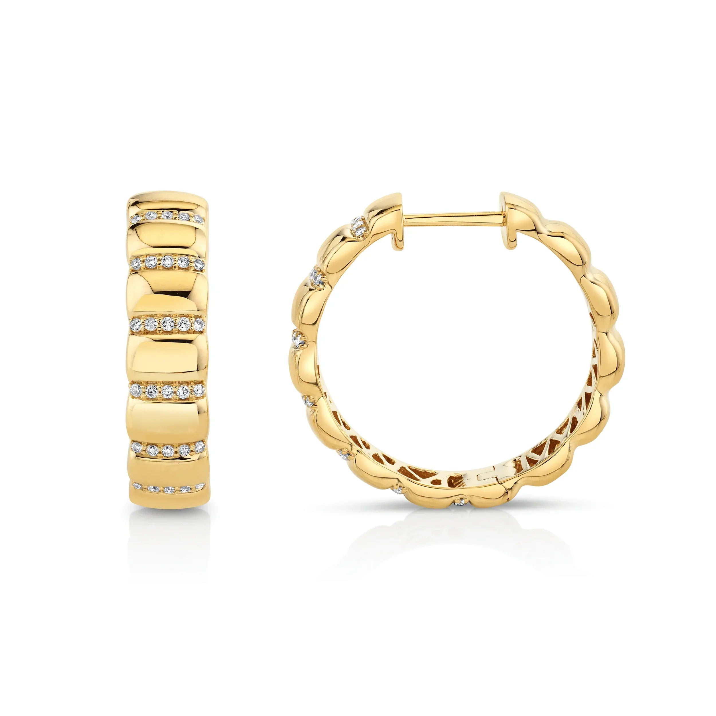 Yellow gold and diamond ribbed huggie earrings on grey background, side and front view