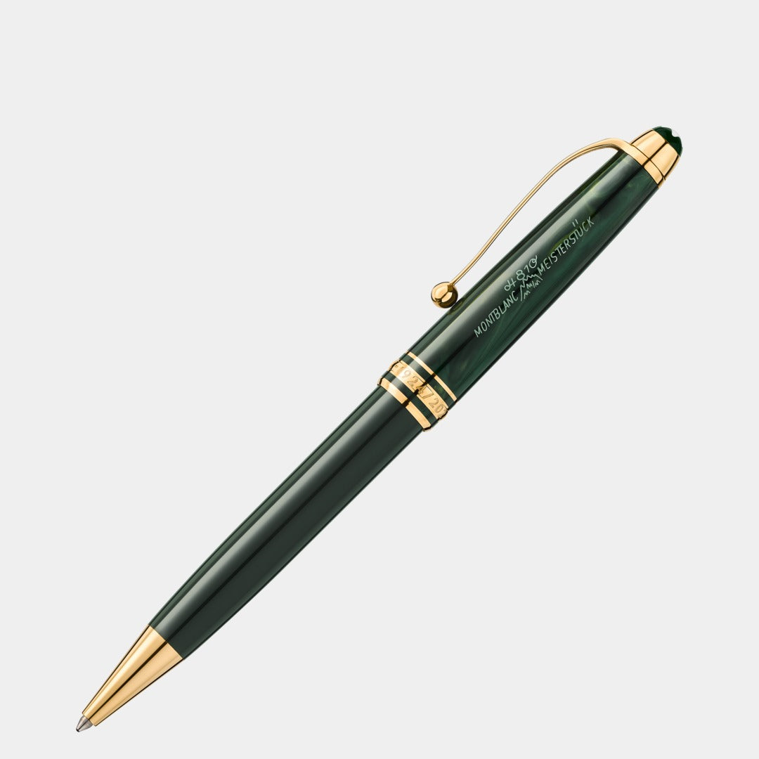Green pen with gold accents on a light gray background