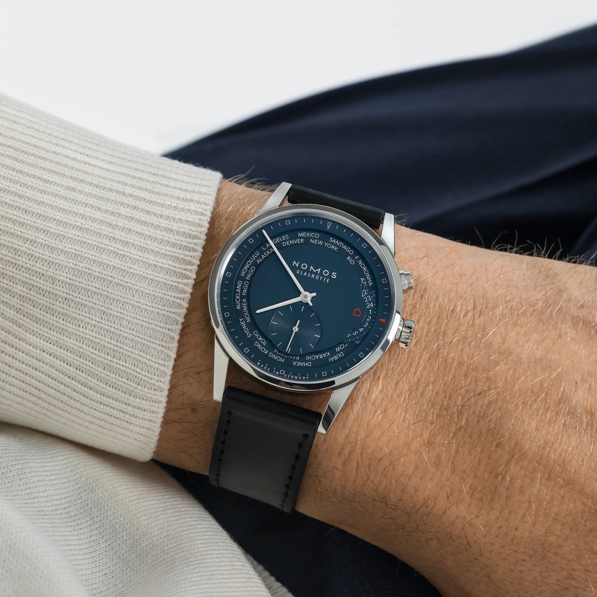 Nomos watch on a wrist with a neutral background