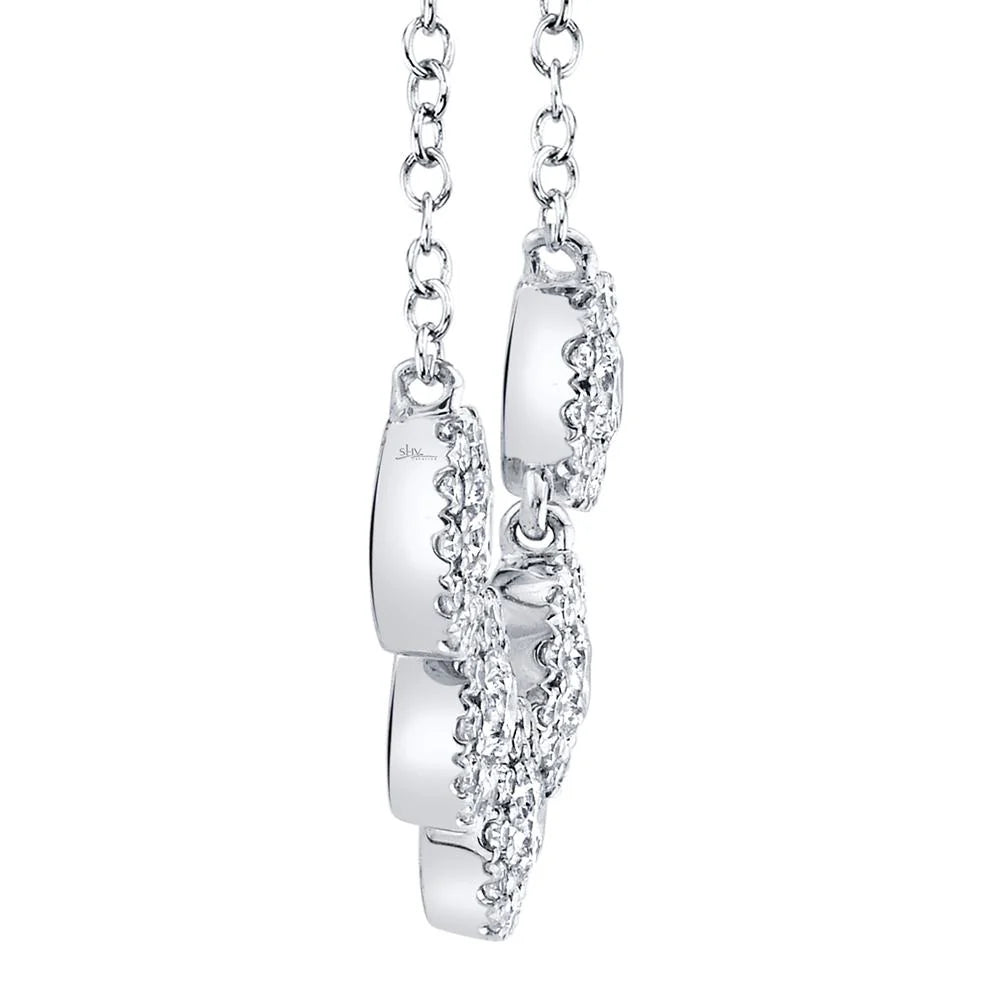 White gold diamond necklace with five diamond solitaire pendants, side view