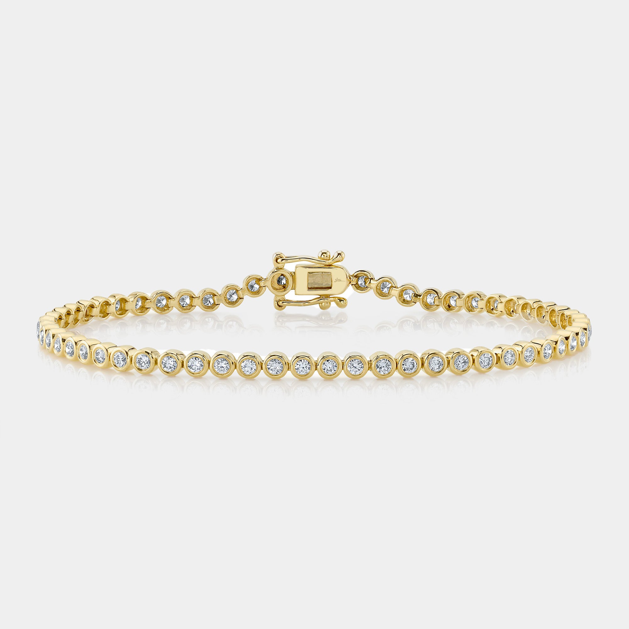 Yellow gold bezel set diamond tennis bracelet, front angle view